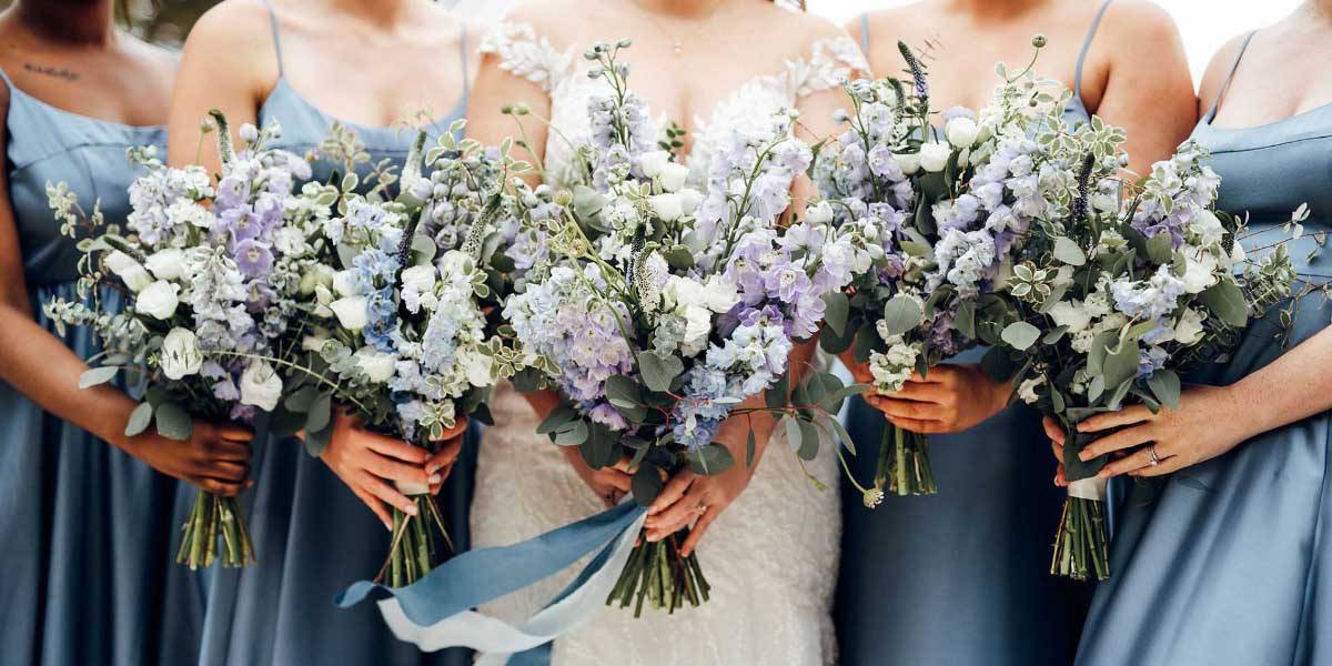 Elegant Bridesmaids' Bouquets A group of bridesmaids in the sunshine holding elegant bridesmaids' bouquets crafted by Plymouth wedding florist Artem Florum.